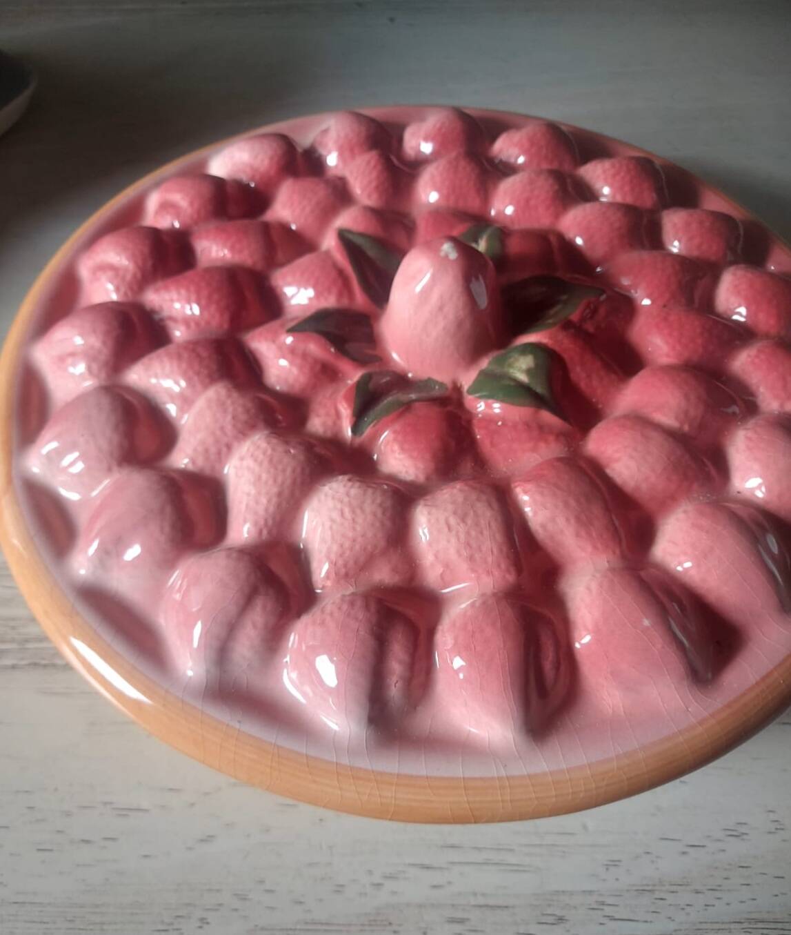 Glazed ceramic dessert plate with strawberry design.