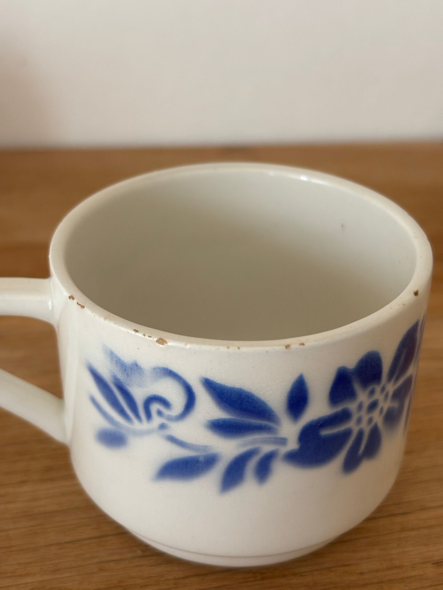 Set of 2 antique earthenware cups with blue floral pattern.