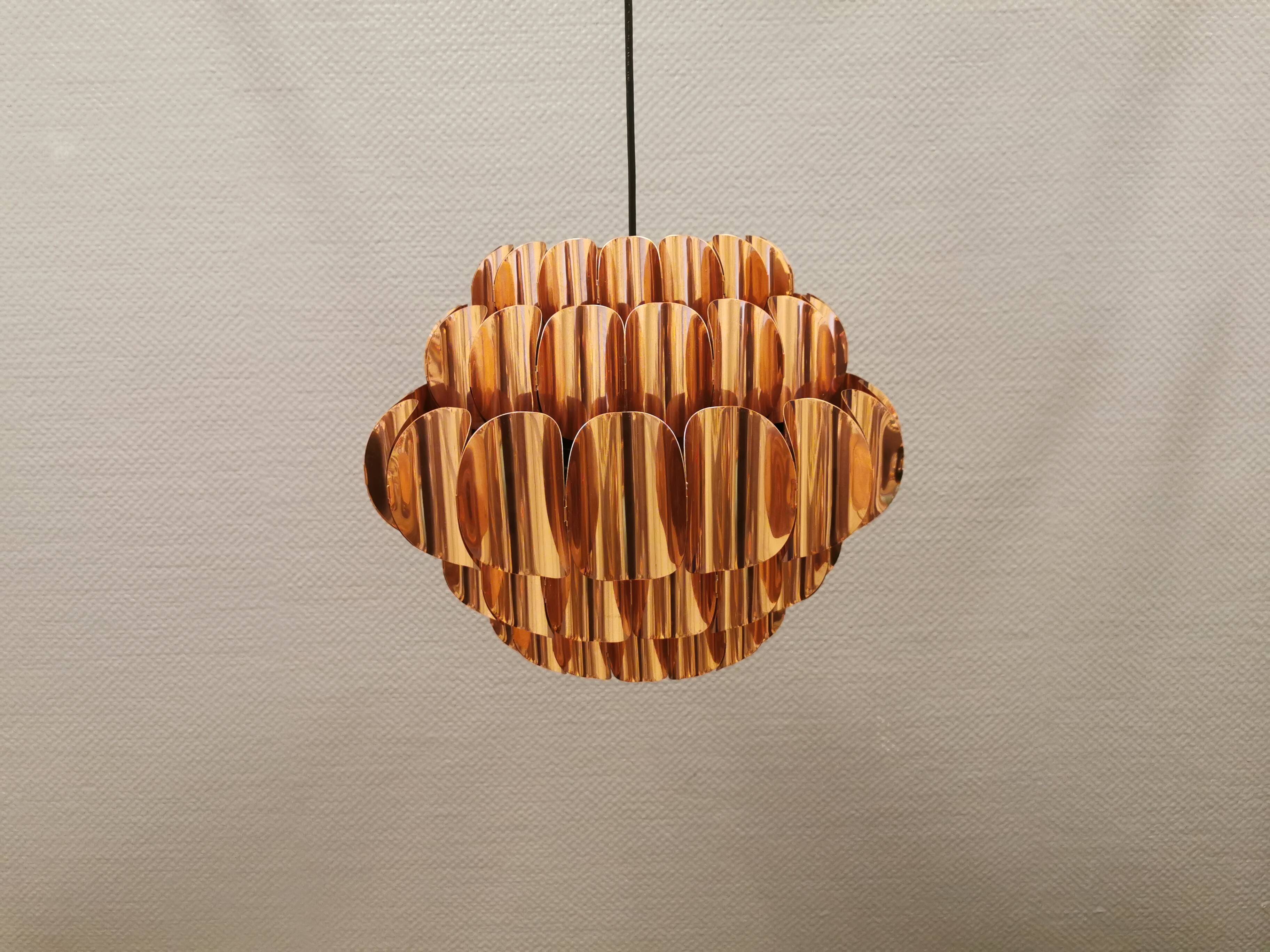 Copper colored hanging lamp. designed by thorsten orrling sweden