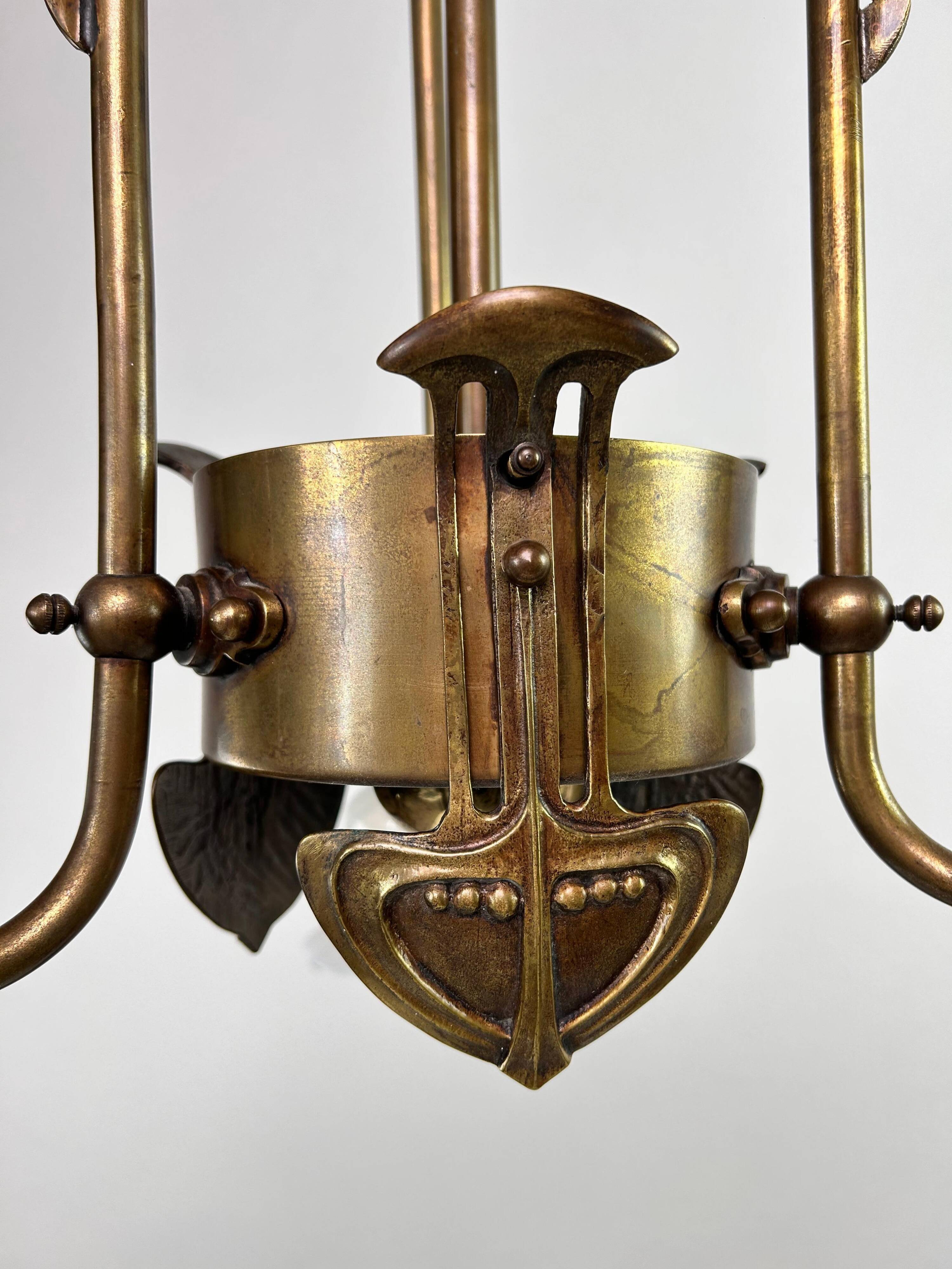 Art Nouveau chandelier with three arms and opalescent iridescent glass.
