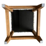 Square pouf with a checkered pattern.