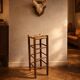 Vintage rustic style bar stool made of solid wood with a straw seat.