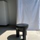 Black mango wood tripod side table with a semi-spherical top, height: 45 cm, diameter: 44 cm.