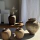 Very large grey and red terracotta pot with handles and rattan crossbars.