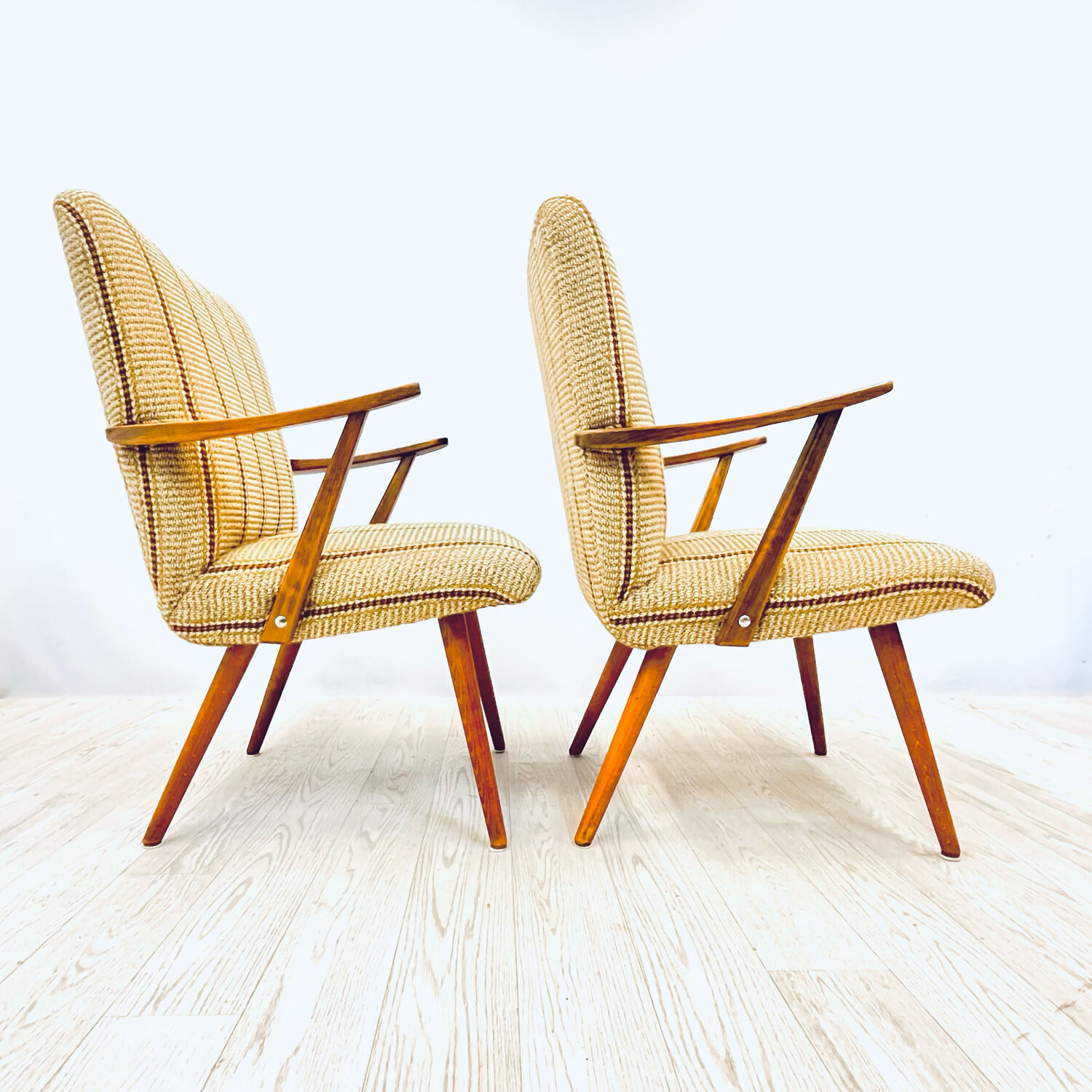 A pair vintage cocktail chairs with stripes and metal screws