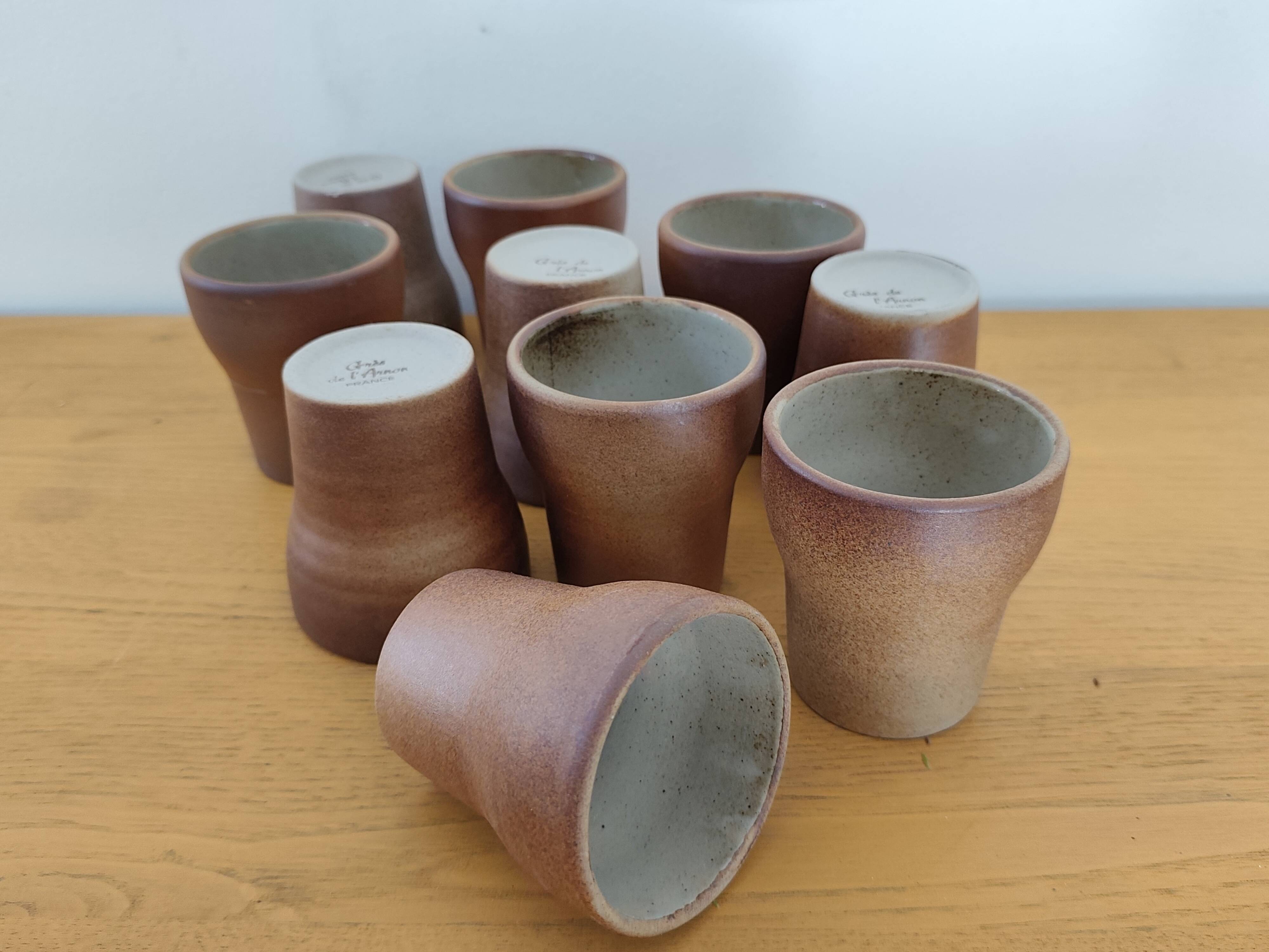 Stoneware cups – Armor stoneware set of 10 and an 11th French stoneware cup.