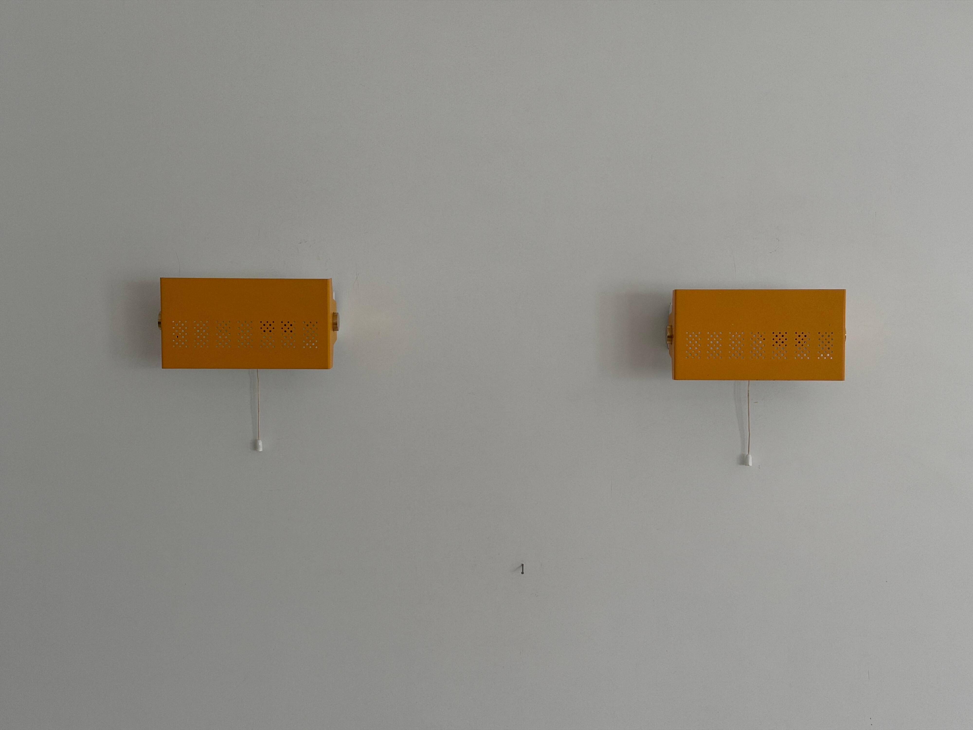 Pair of yellow metal wall lights from the mid-century by N Leuchten, 1960s, Germany.