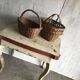 Set of 2 brown wicker baskets from the 1960s — decorative weaving and double handles.