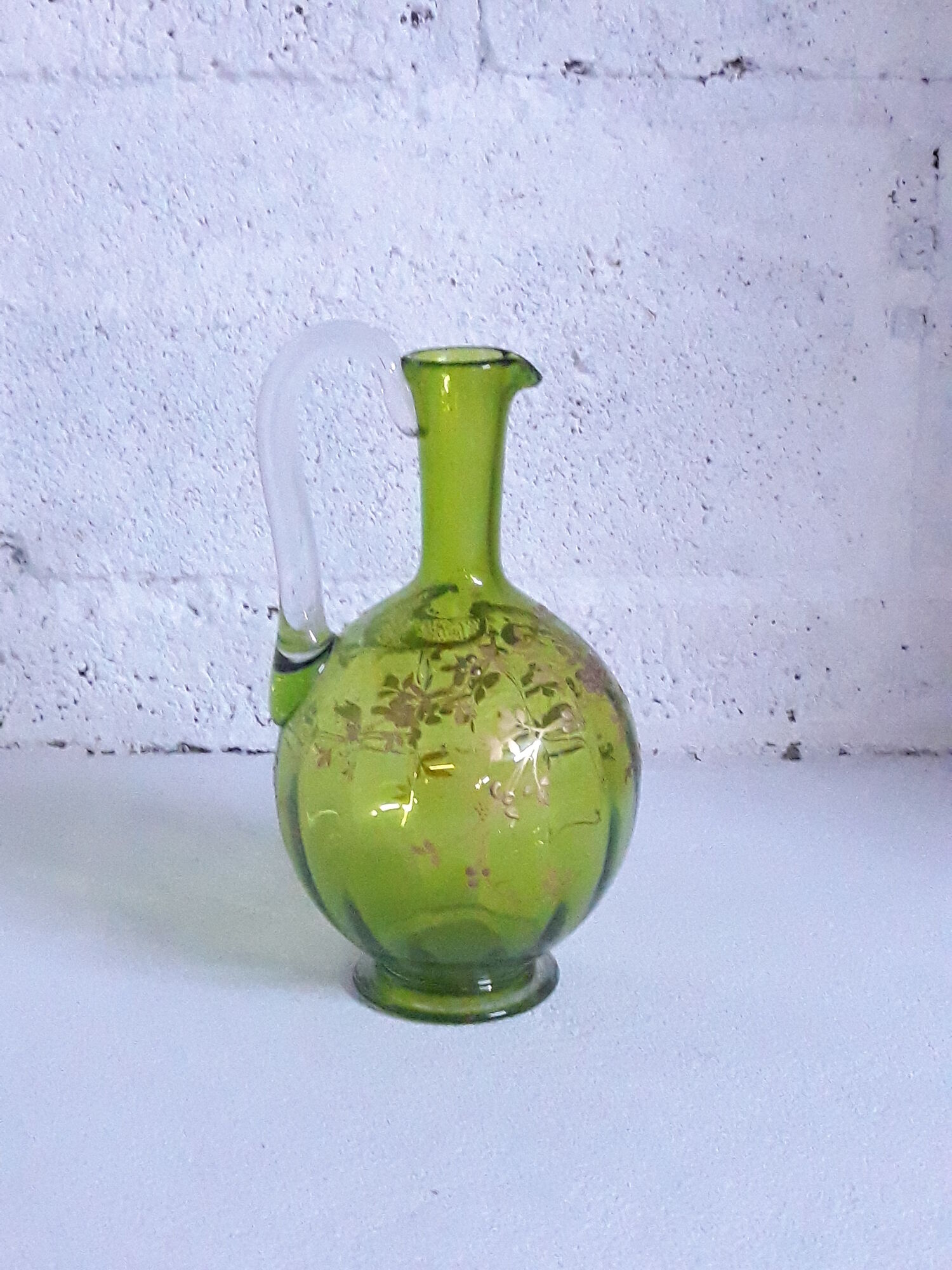 Small carafe and green glass drop glasses with rococo golden emailed decor