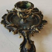 Antique Baroque/Rocaille style hand candle holder. In bronze with an old gold patina.