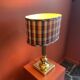 Lamp base in gilded brass, oval silk lampshade with a checkered pattern in burgundy.
