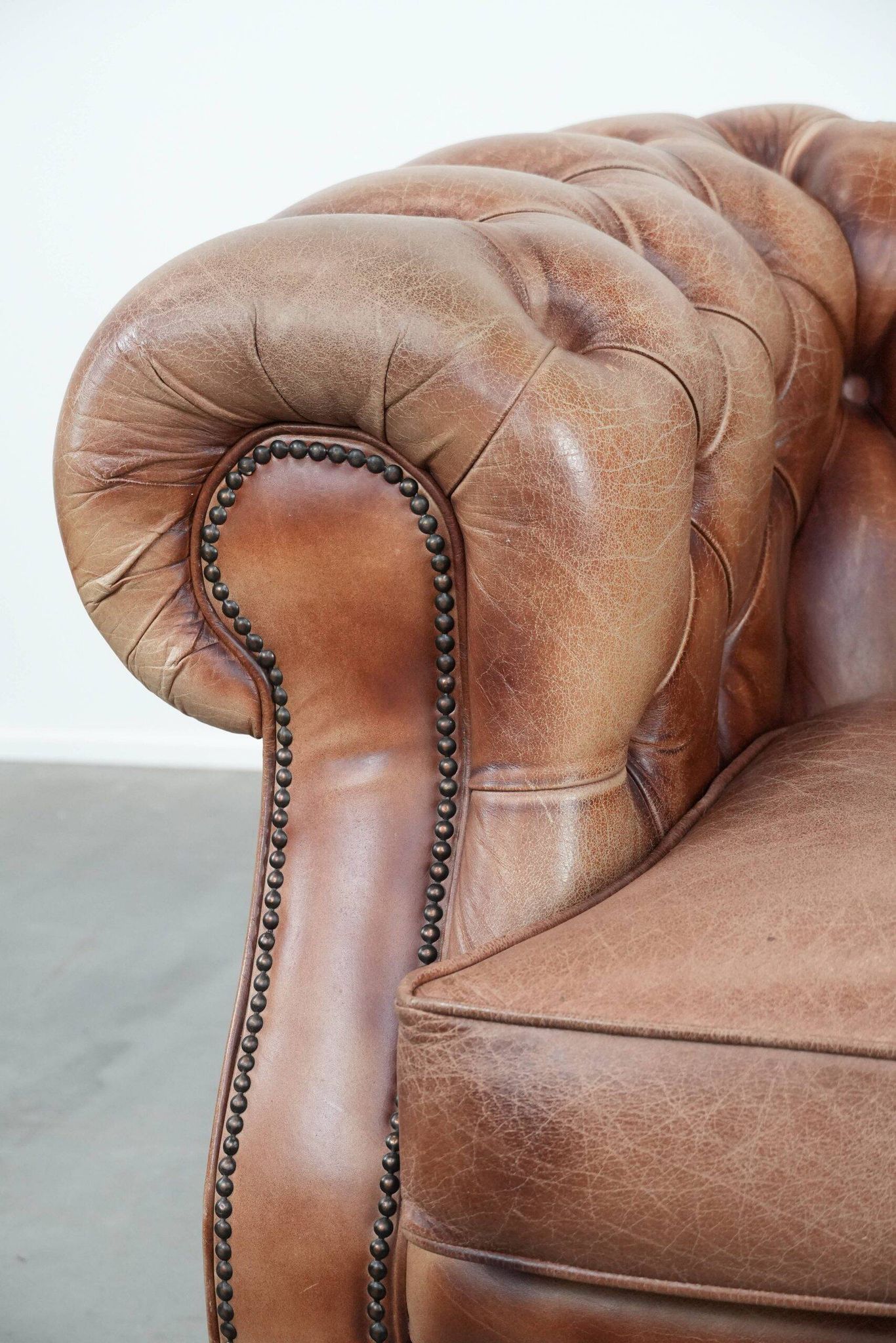 Chesterfield armchair in English style made of cowhide leather