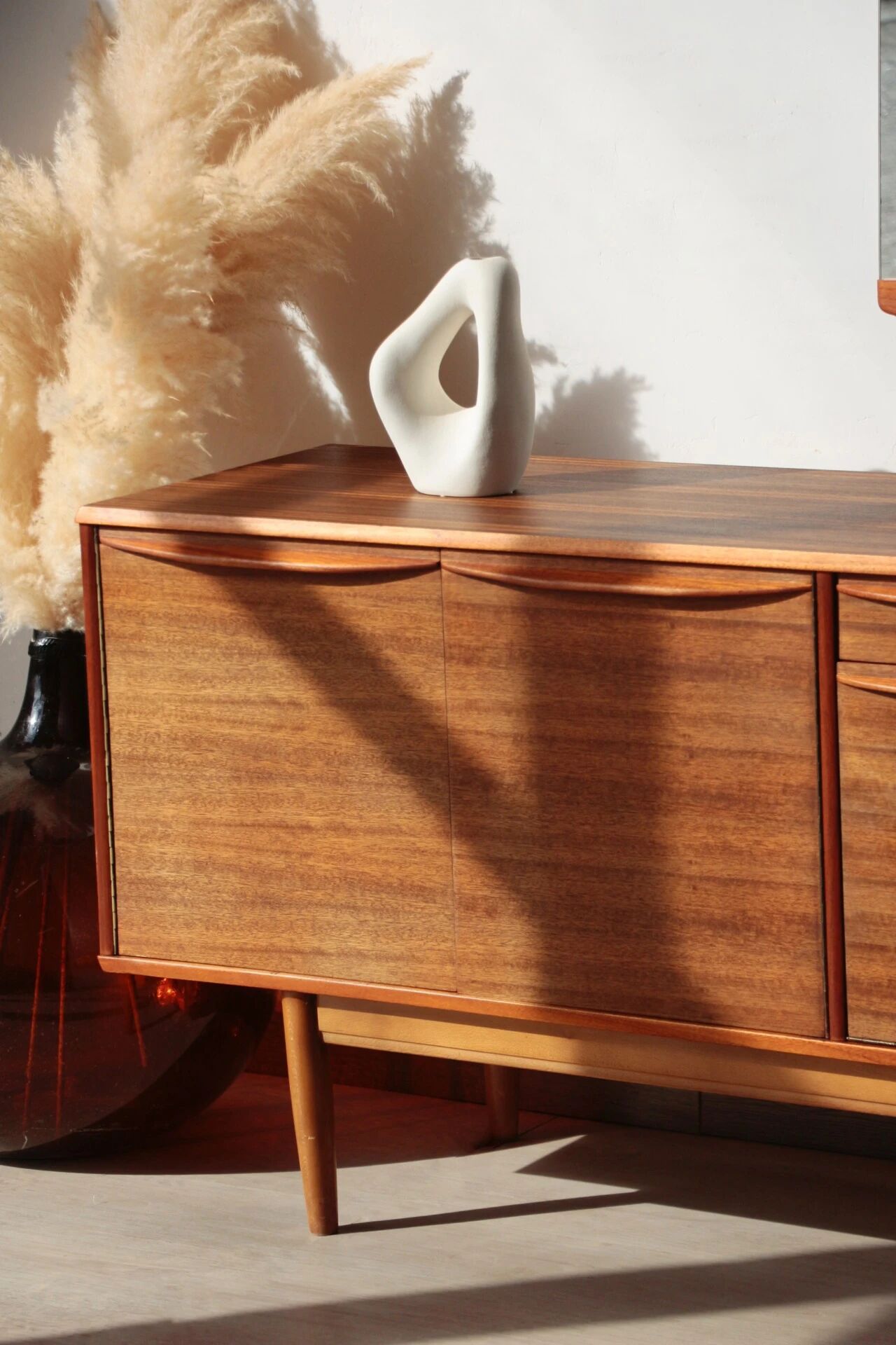 Vintage zebrano and walnut furniture from Morris of Glasgow.