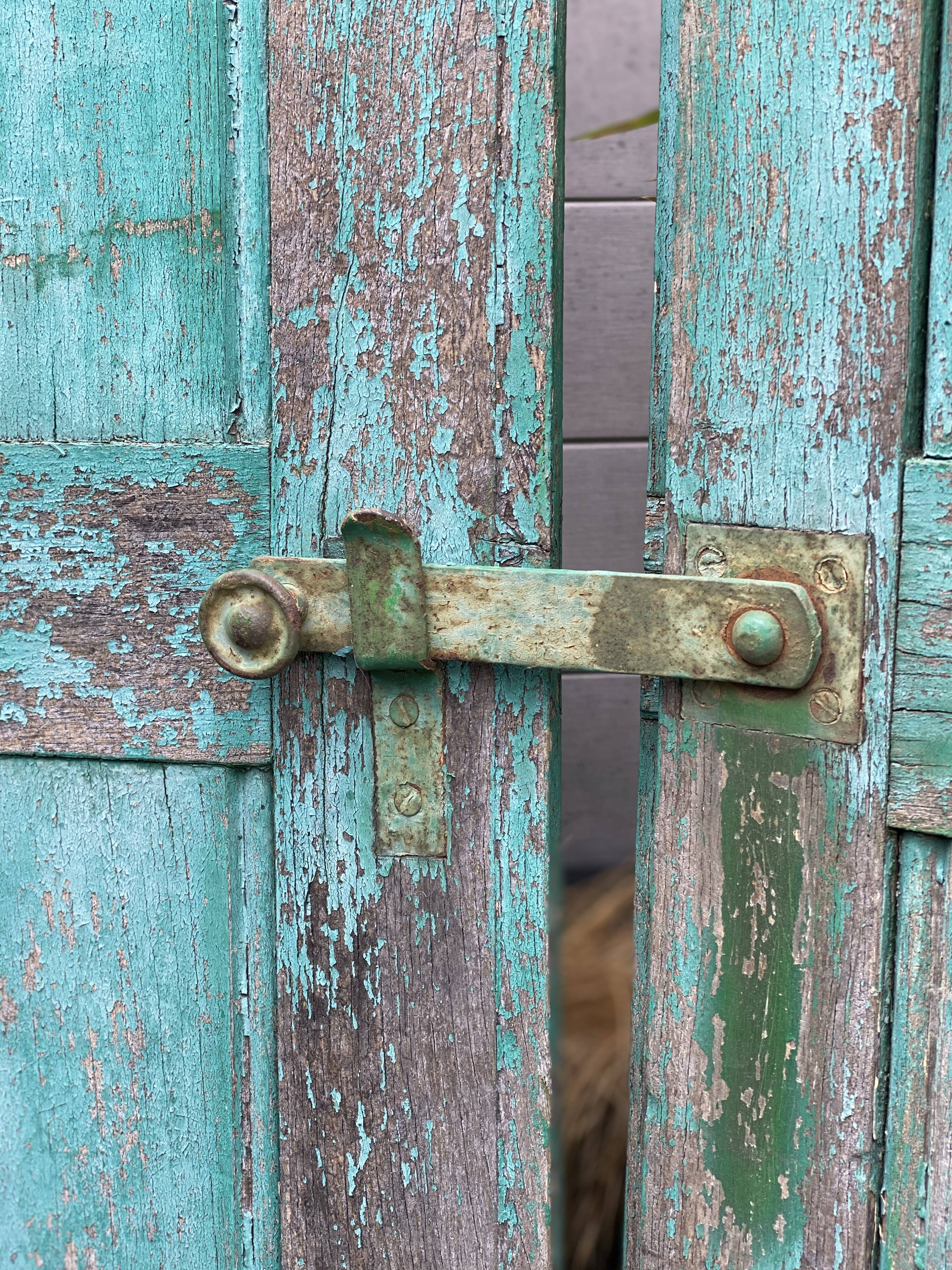 Pair of old wooden shutters green mint color