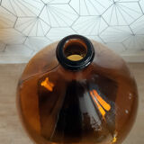 Great old demijohn in amber glass