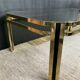 Table basse vintage années 70 en métal doré et verre fumé