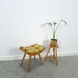 Vintage footrest with checkered cushion