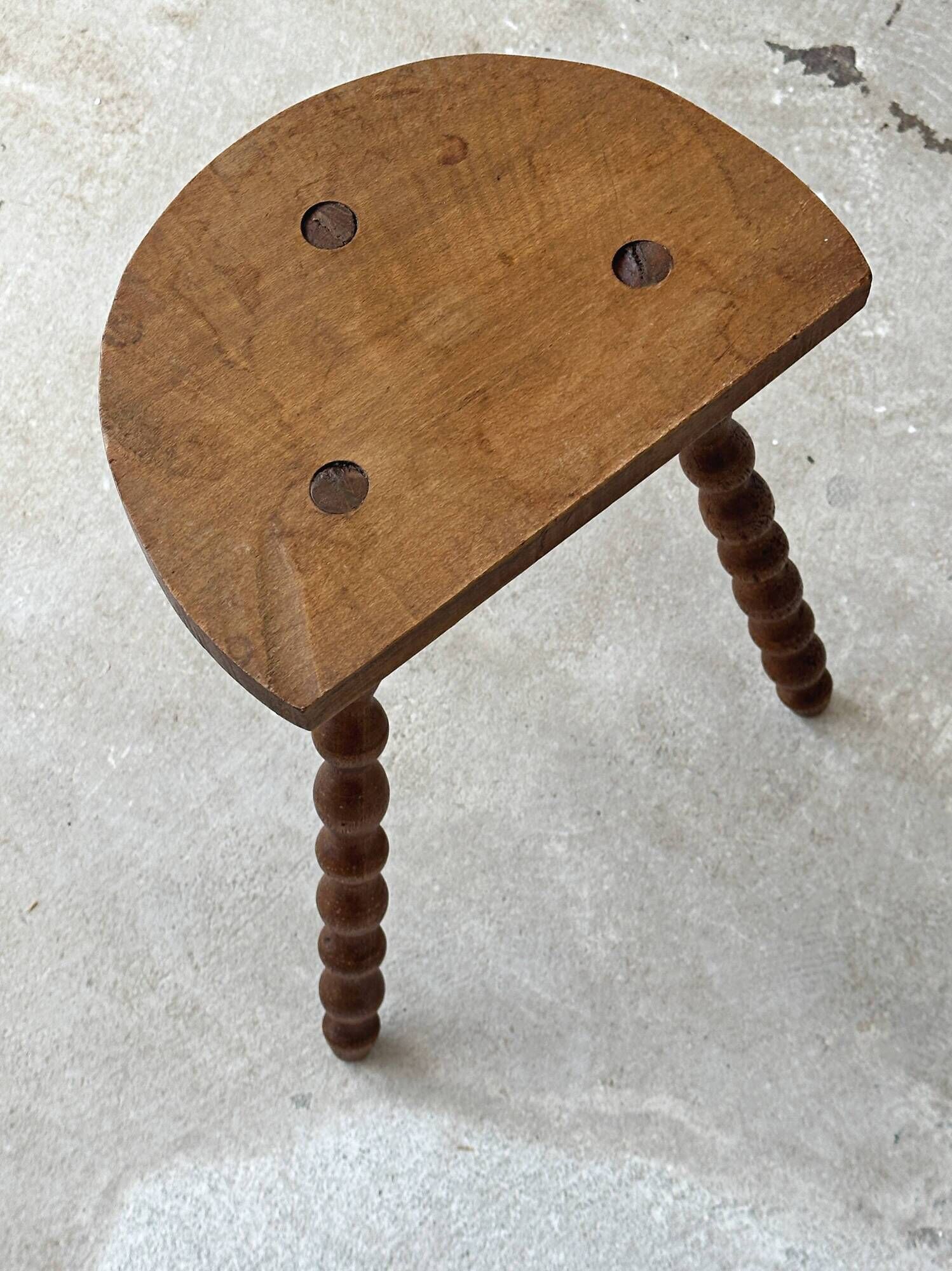 Antique solid wood stool with turned legs.