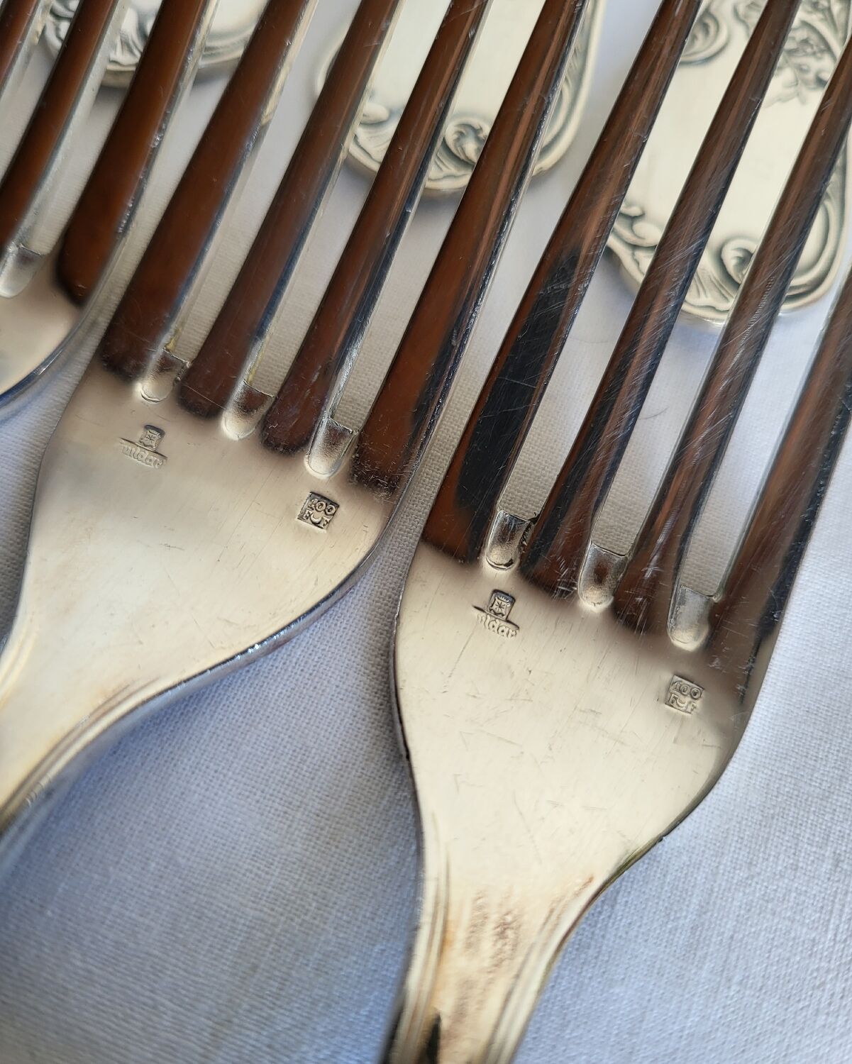12 large silver-plated metal table forks by Guildart