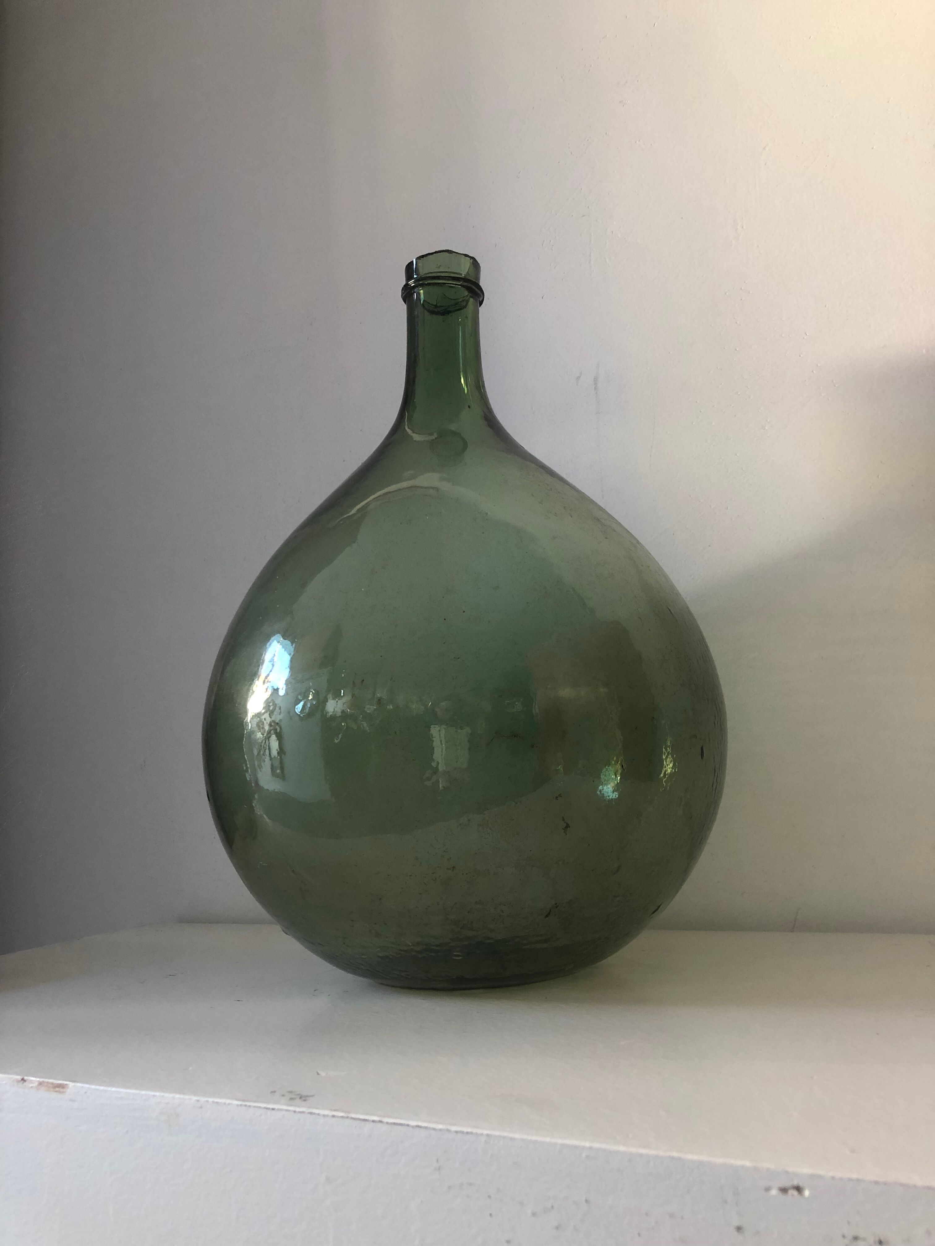 Demijohn old bottle in blown glass