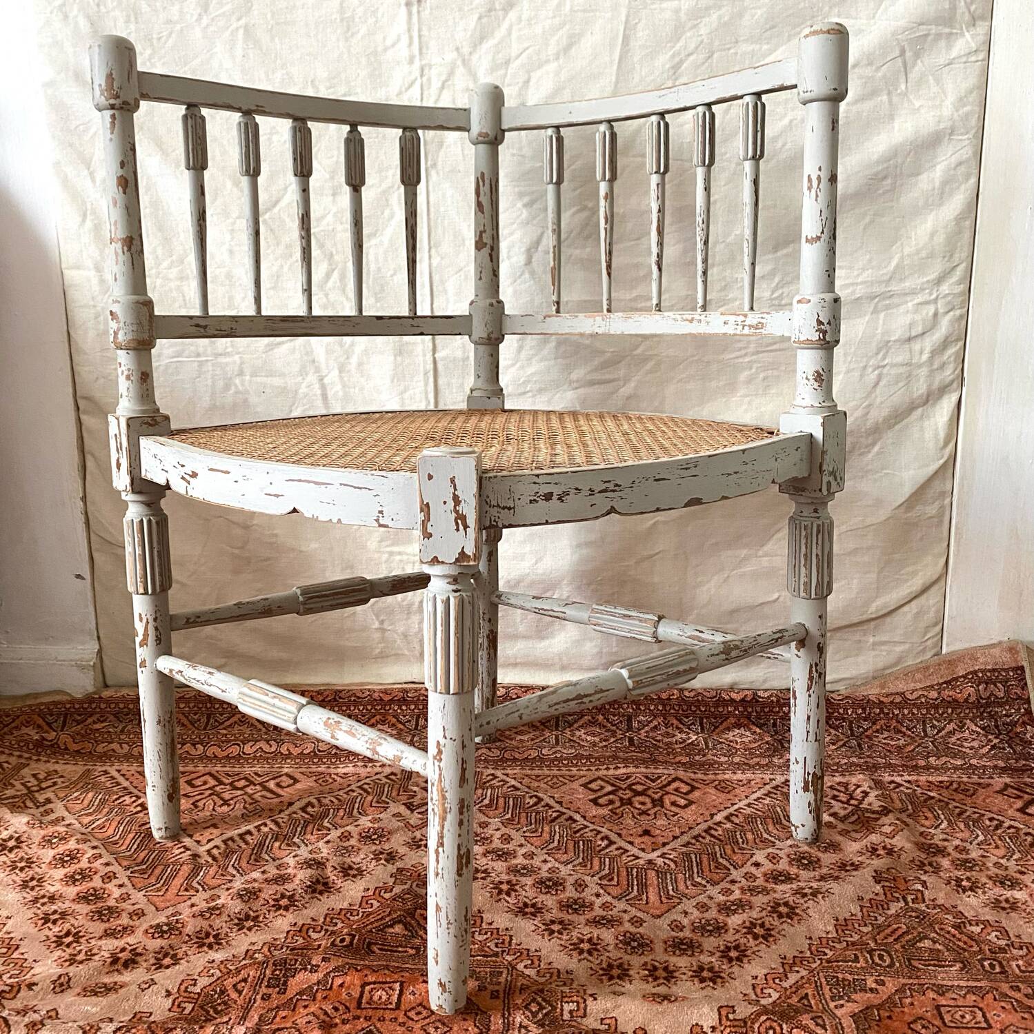 19th-century corner fireplace armchair, wood and cane.