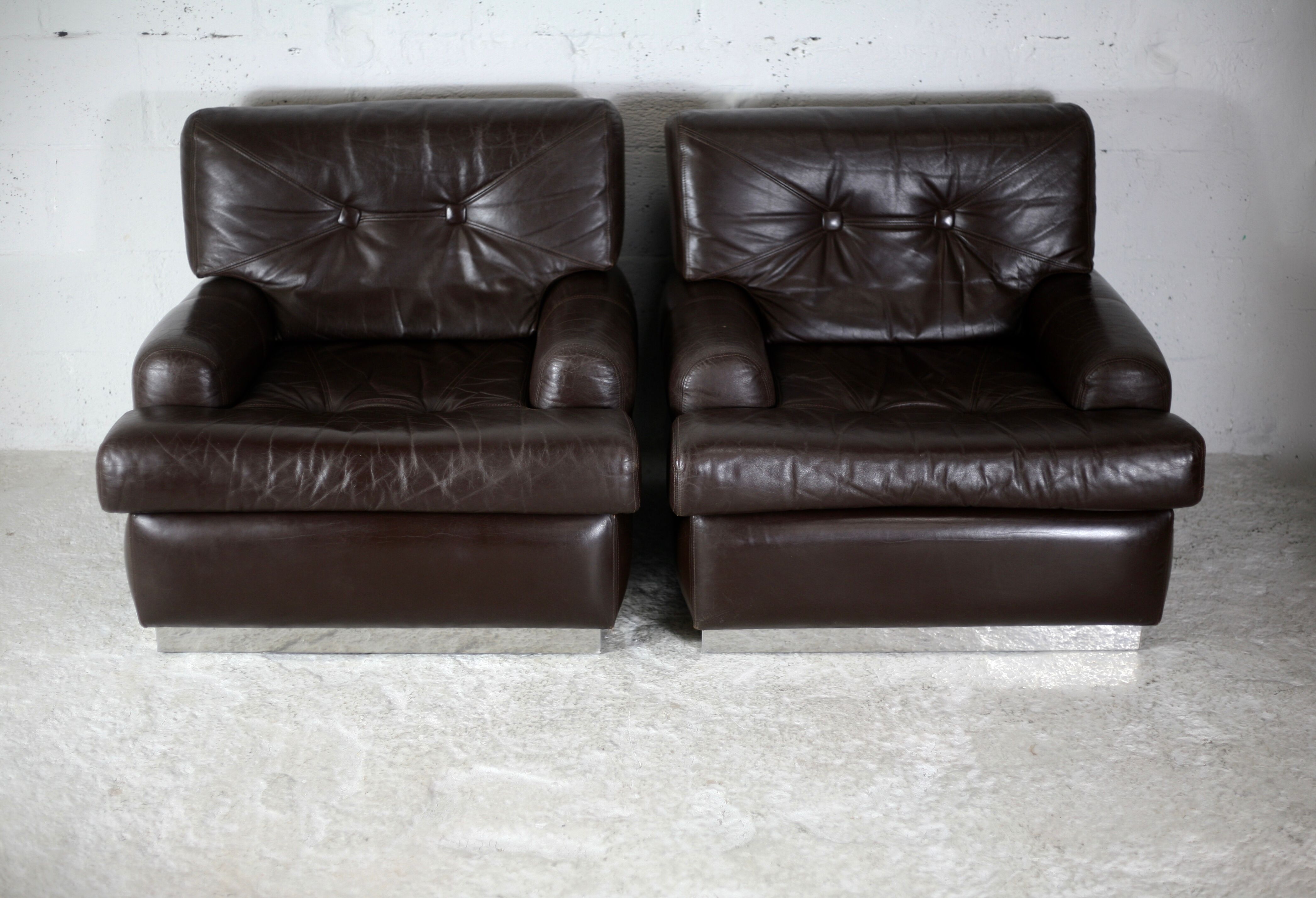 Pair of armchairs brown leather base stainless steel, France, circa 1970