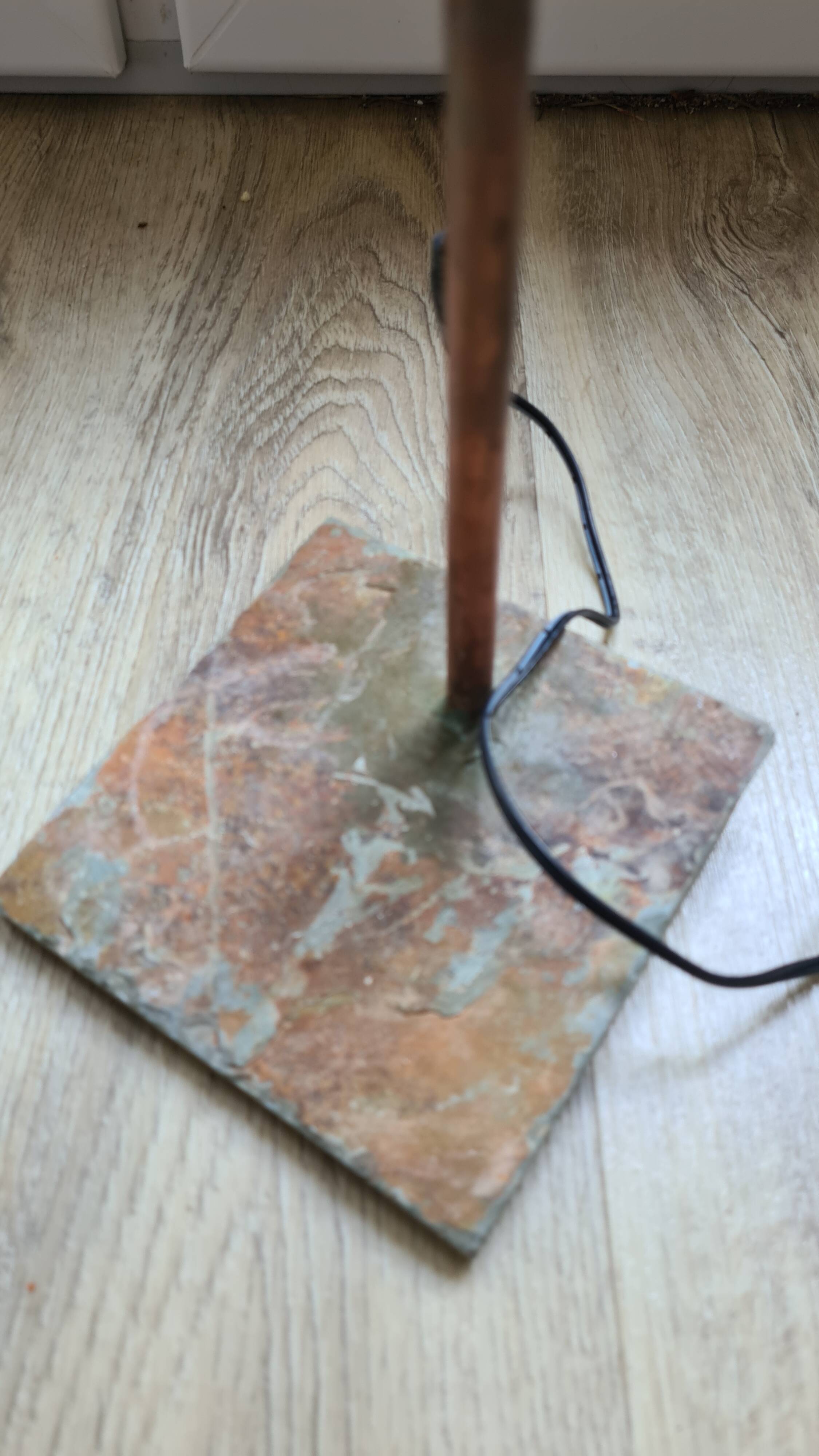 old lamp with stone base and copper arm