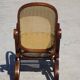Vintage wooden rocking chair with caning