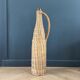 Amber glass bottle in its wicker handle basket.