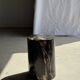 Black petrified wood side table with beige stripes, star pattern H35 D24.