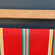 Vintage deck chair with striped green and red fabric, original patina.
