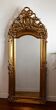 Large antique baroque mirror with angel decorations.