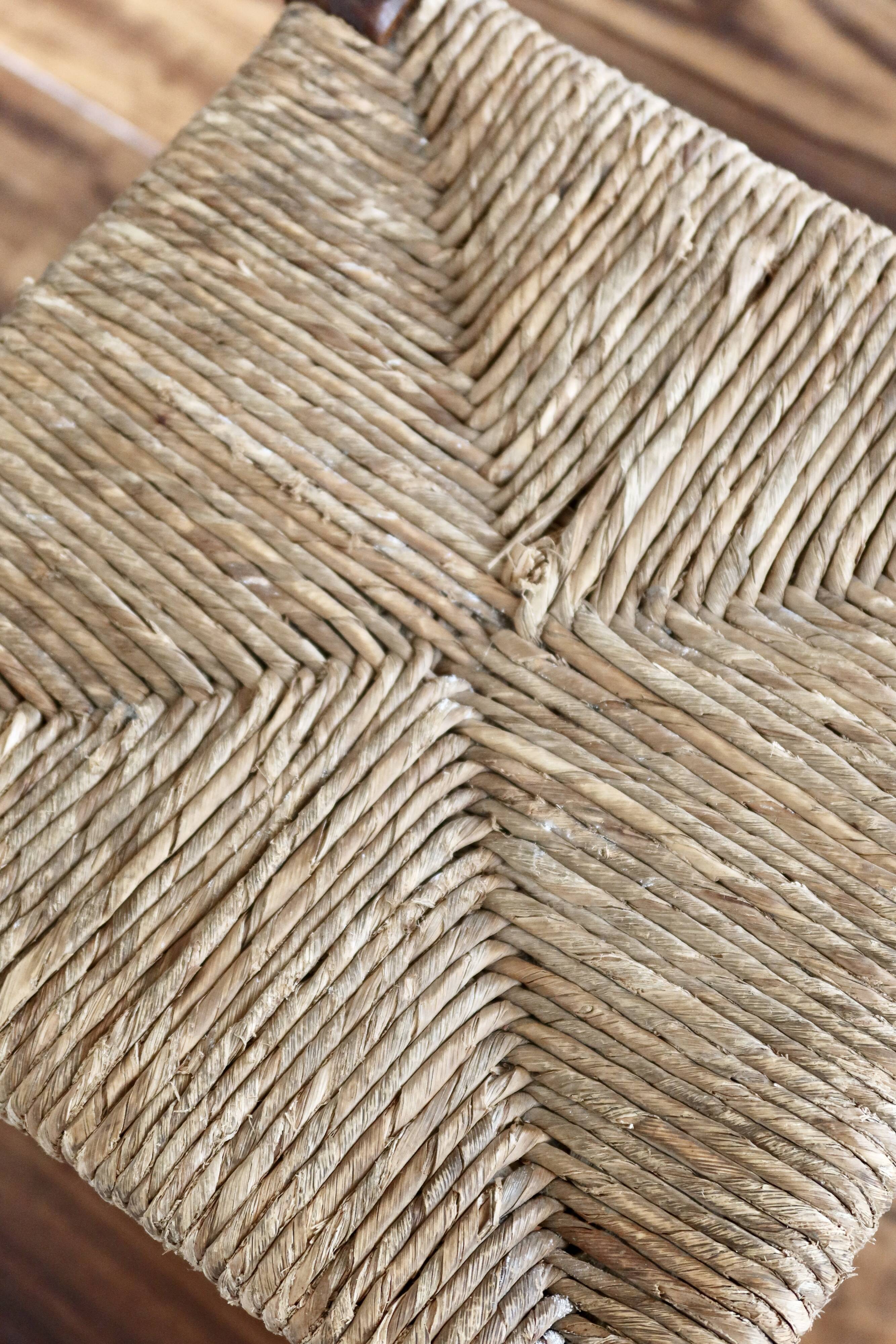 Rustic old stool made of wood and straw.