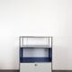 USM Haller furniture in gentian blue and white with a drop-down door on wheels.