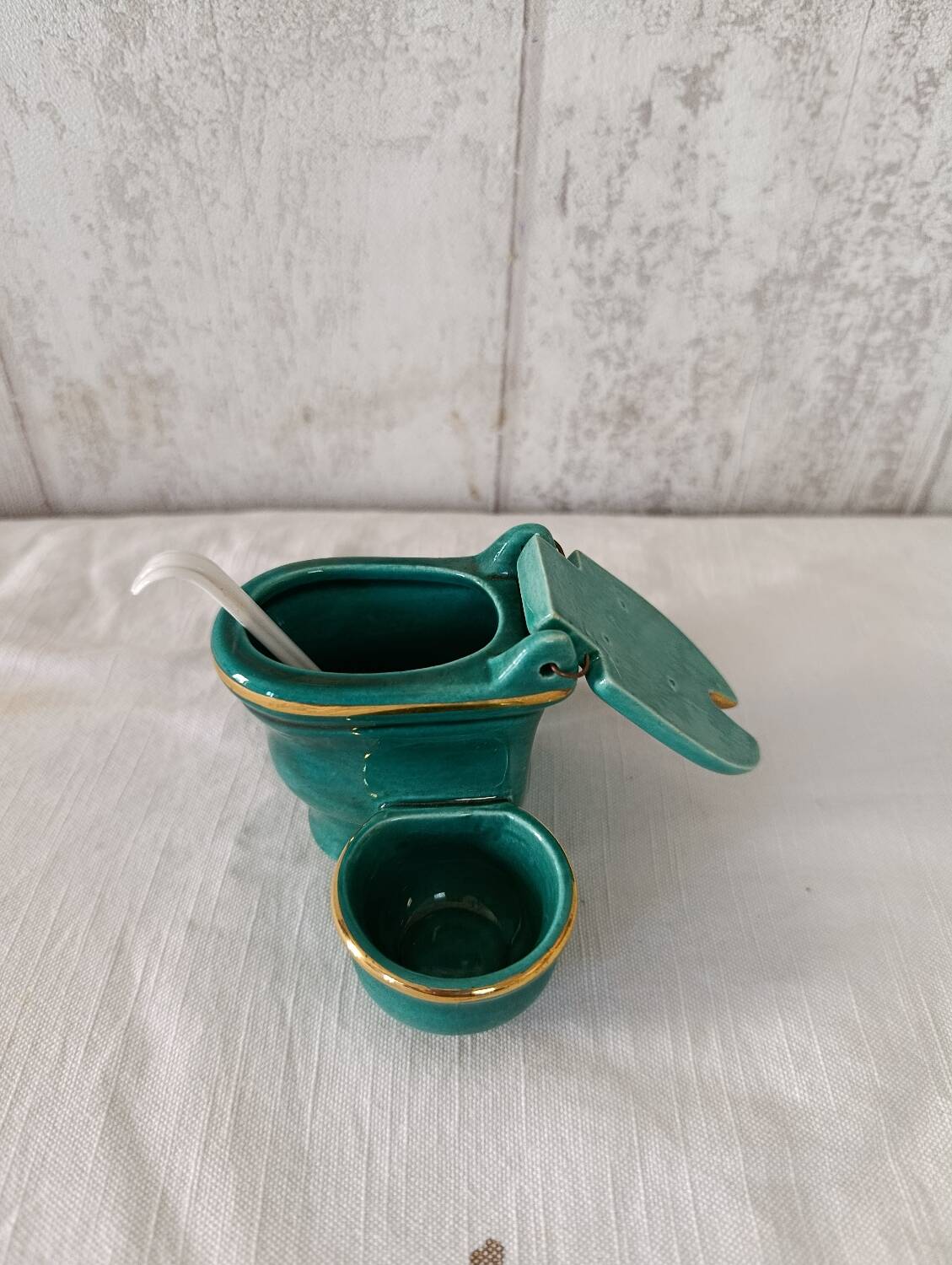 Mustard and salt pepper shaker in the shape of a toilet.