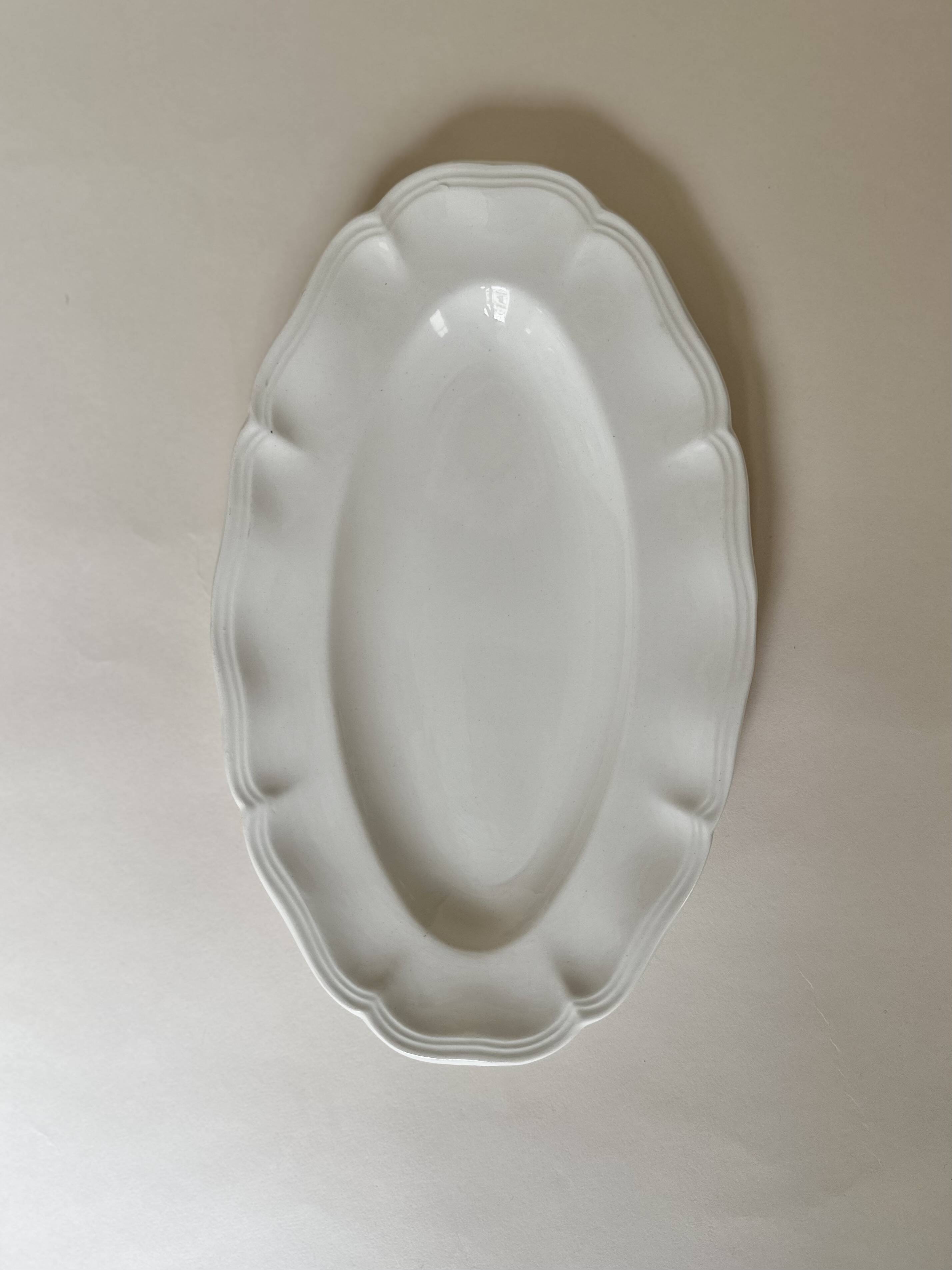 Shaped plates and dishes in Sarreguemines earthenware.