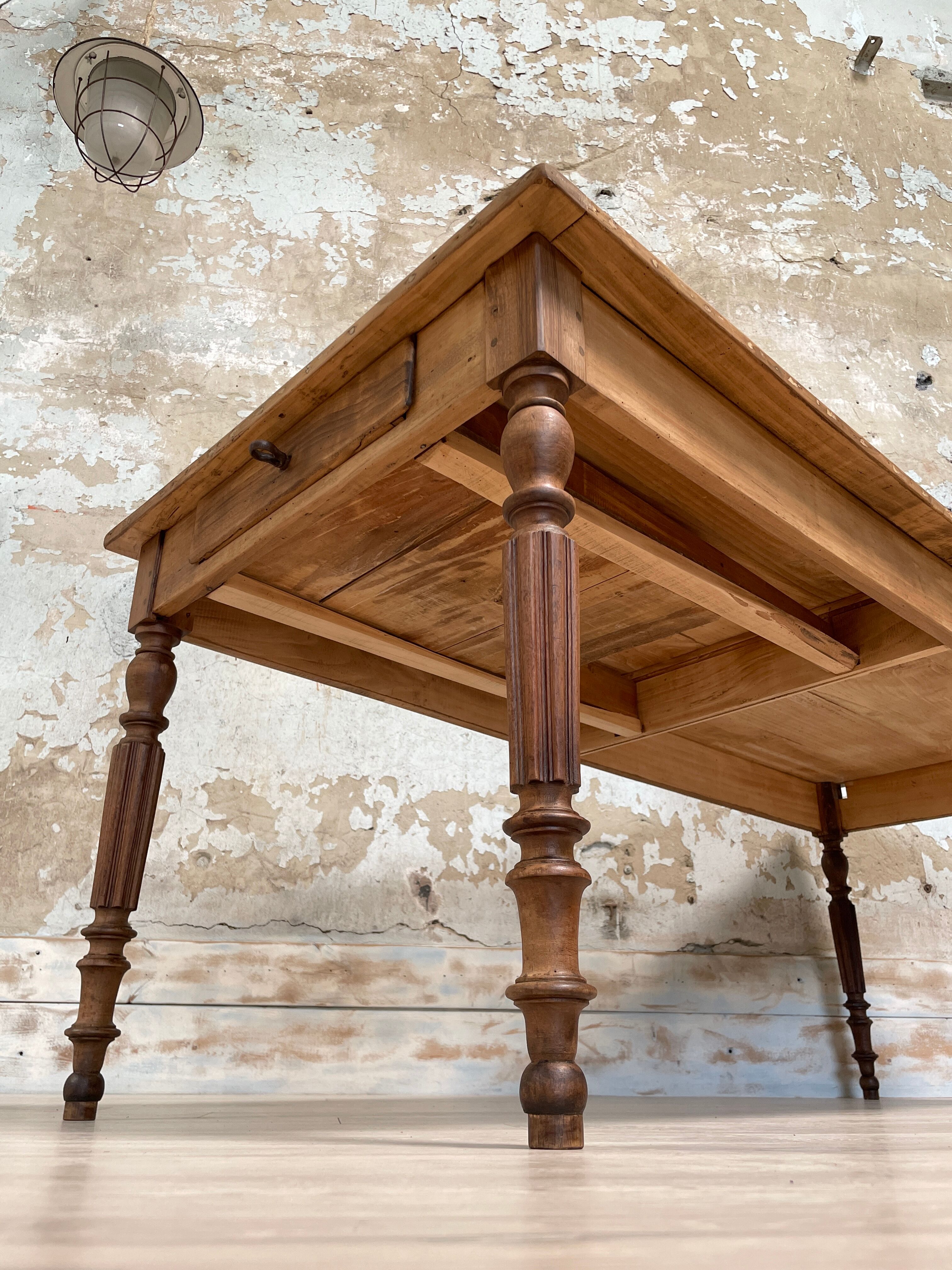 Vintage farmhouse table with turned legs.
