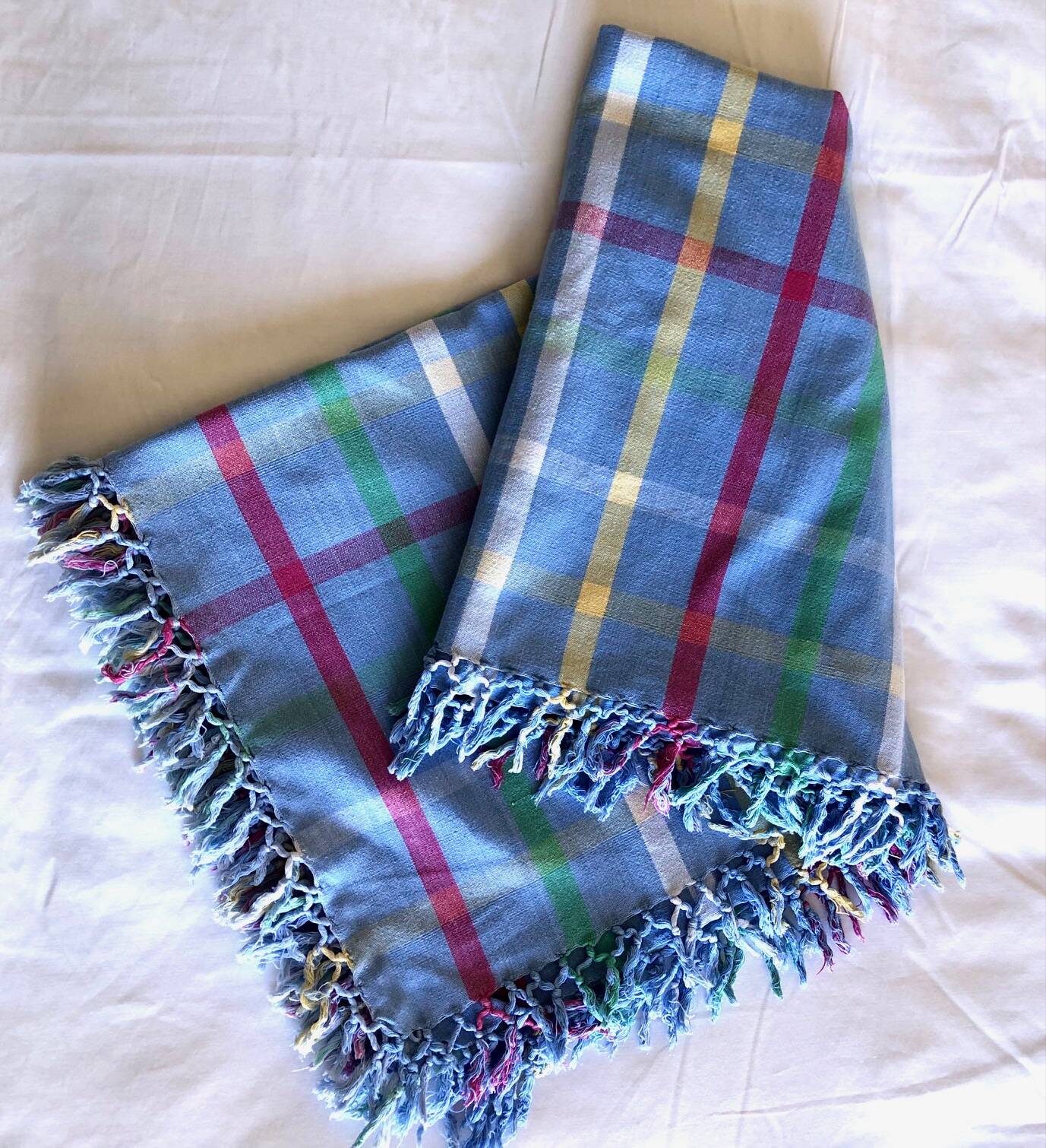 Vintage tablecloth & napkins, blue with multicoloured stripes.