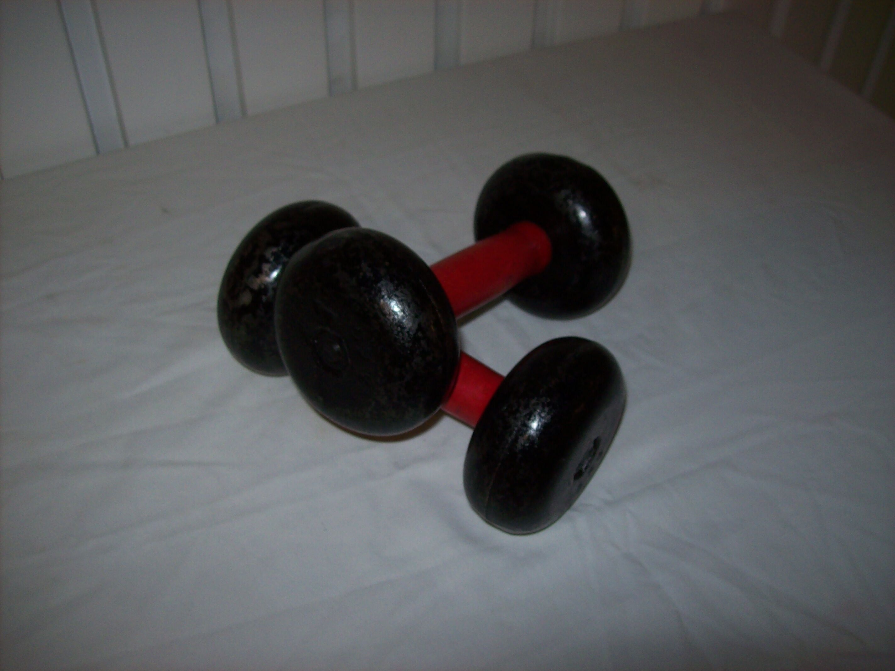 Red wooden and cast-iron dumbbells