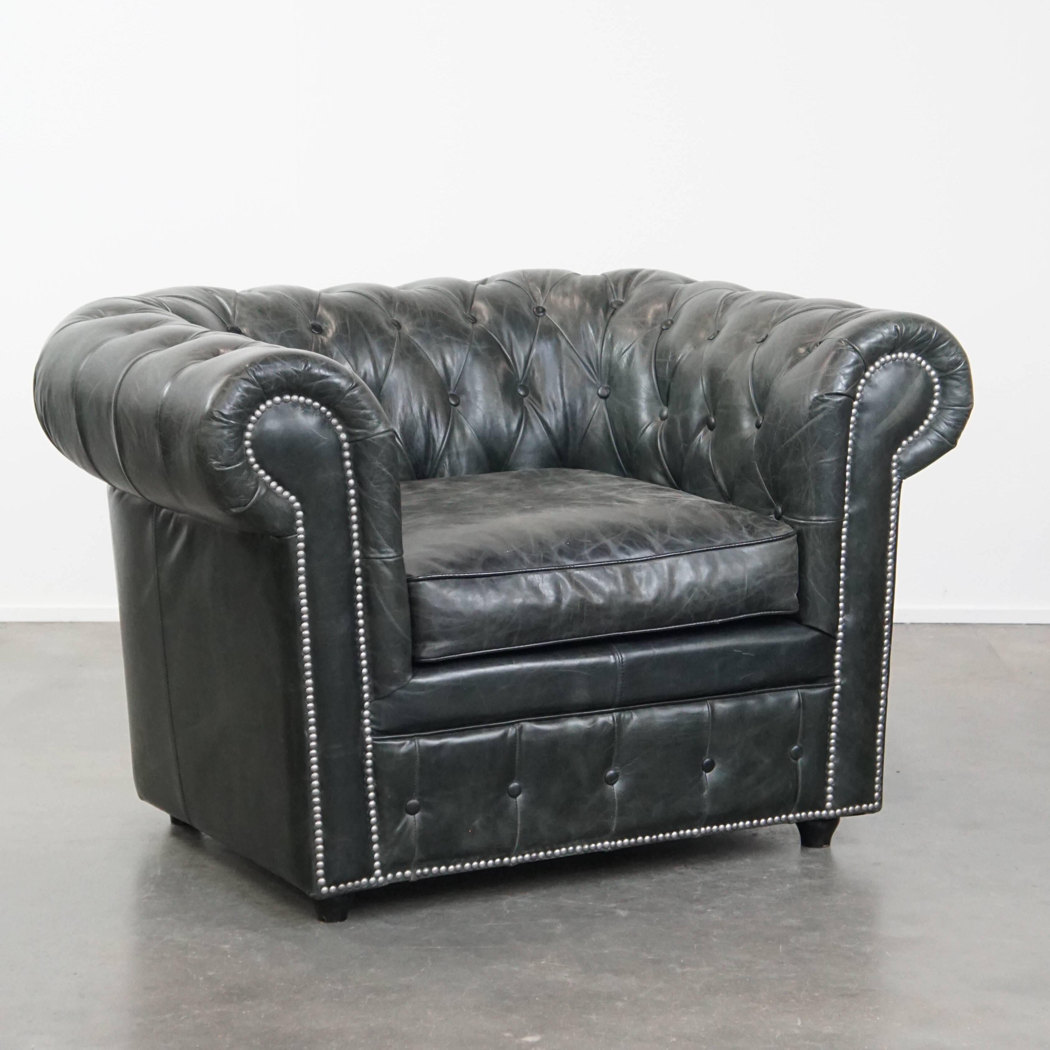 Black Chesterfield armchair made of grained cowhide leather