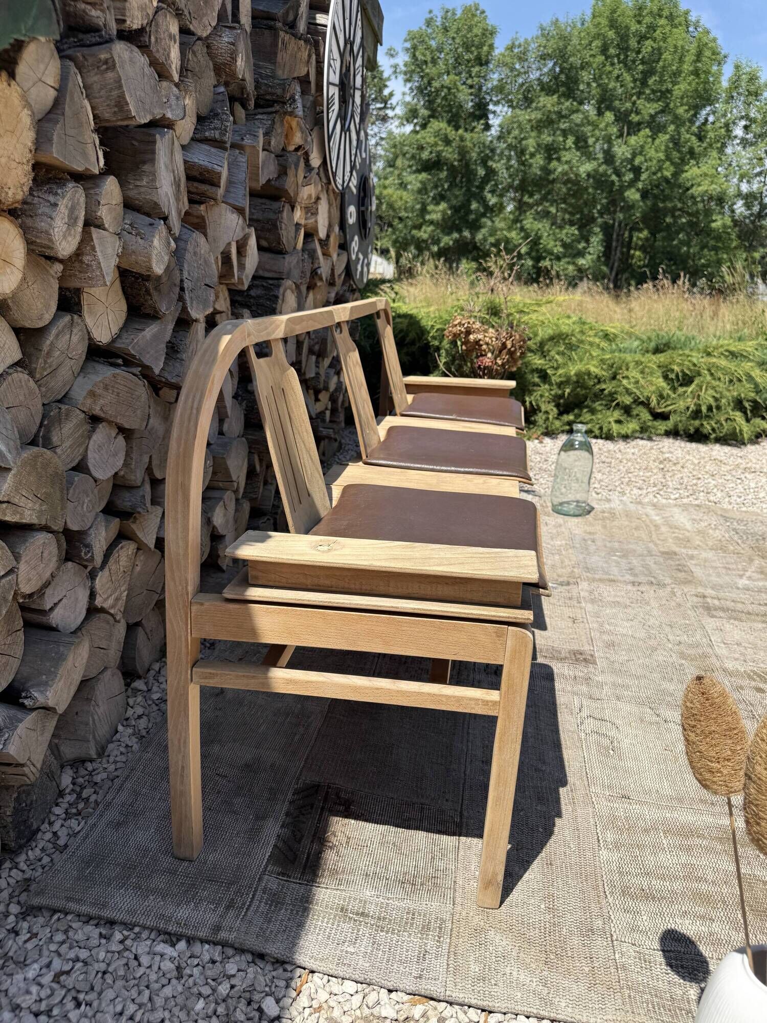 Baumann bench with wooden frame and faux leather seat.