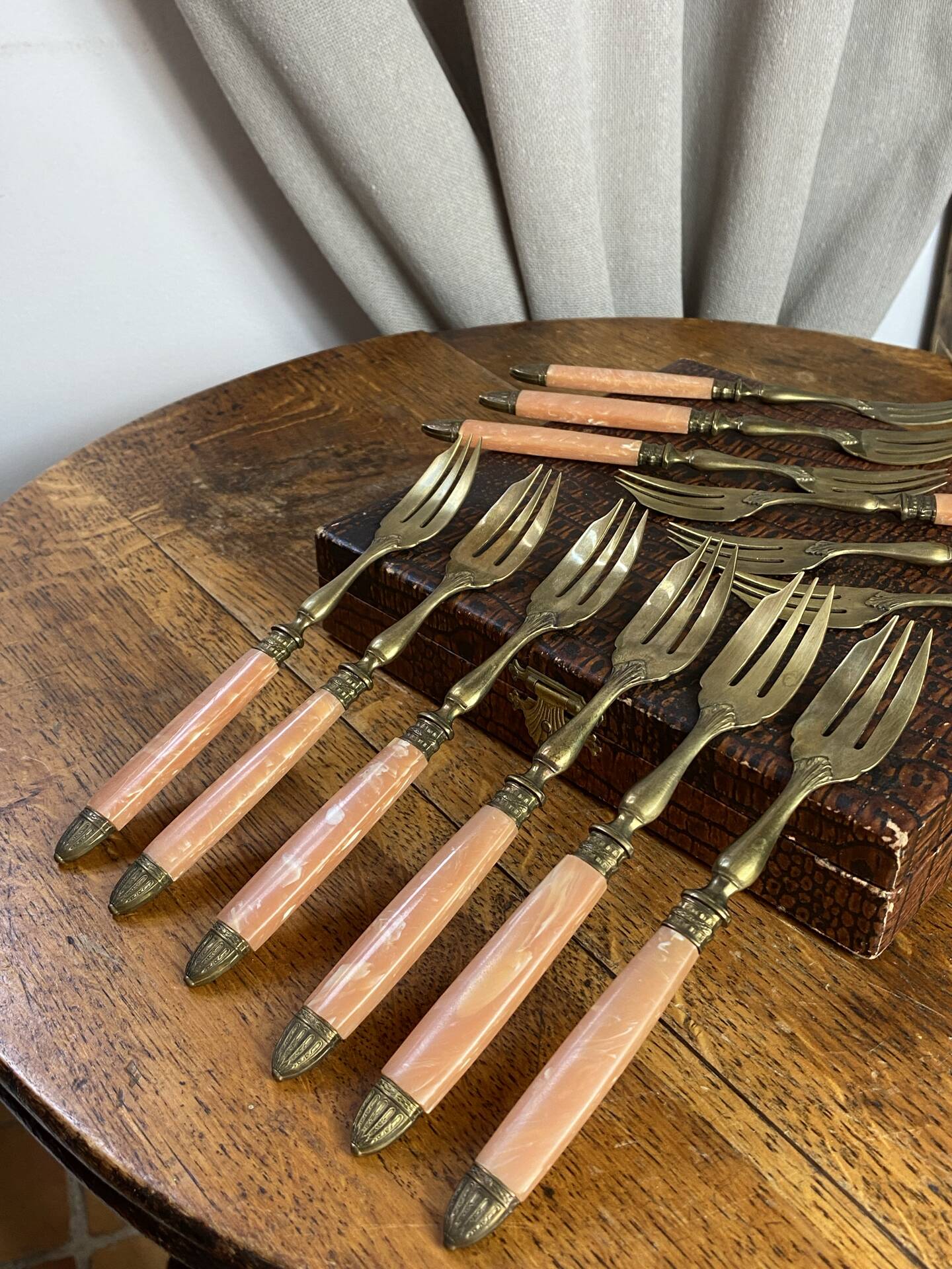 Dessert forks in brass and Bakelite in their case.