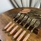 Dessert forks in brass and Bakelite in their case.