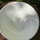 Old footed bowl in earthenware with pink decoration and defects.