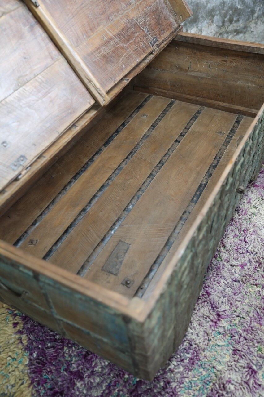 Low chest with metal closure and top opening.