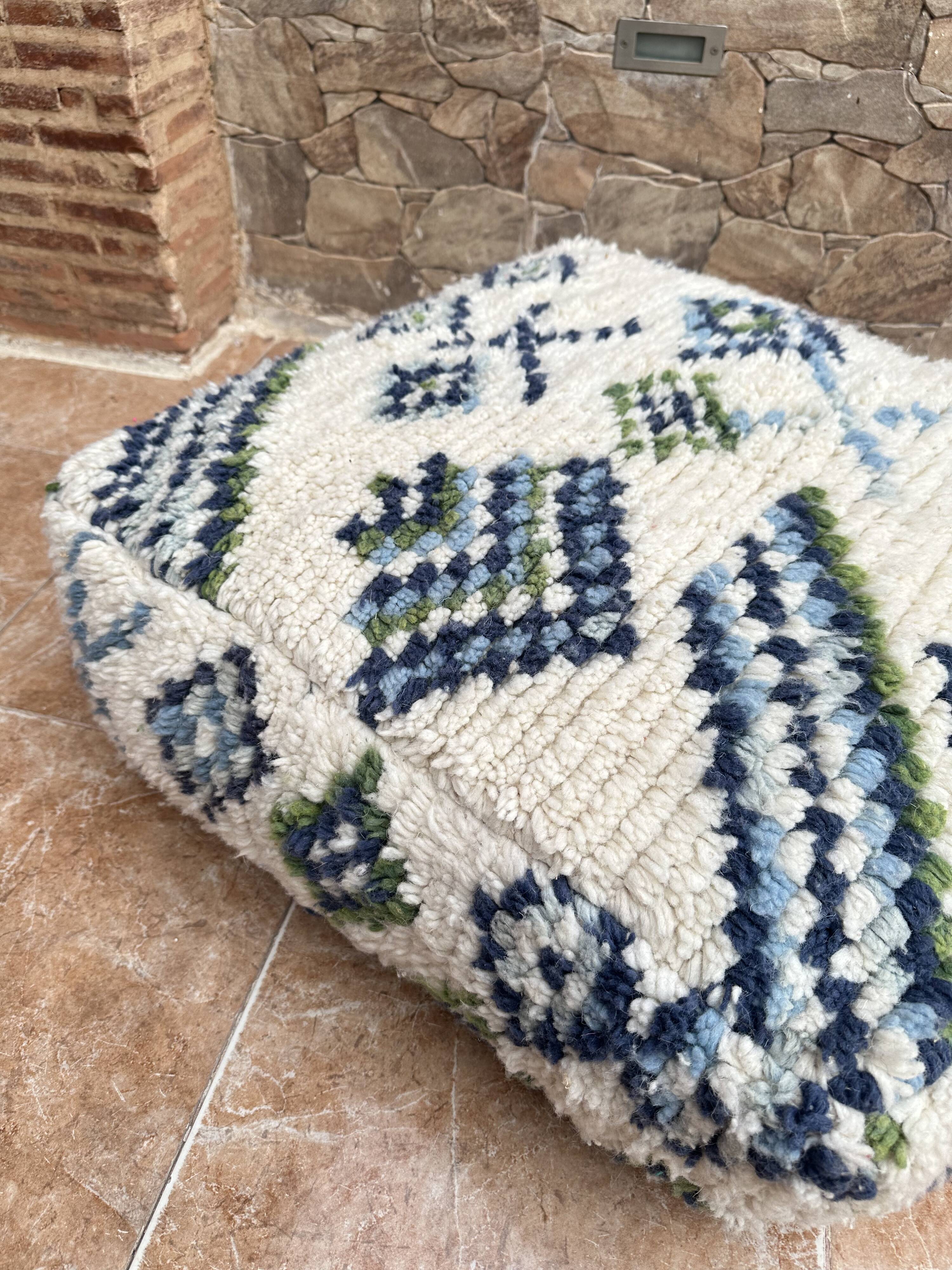 Berber floor pouf: Handwoven Moroccan wool cushion.