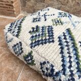 Berber floor pouf: Handwoven Moroccan wool cushion.