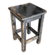 Solid wood stool with a worn black patina.