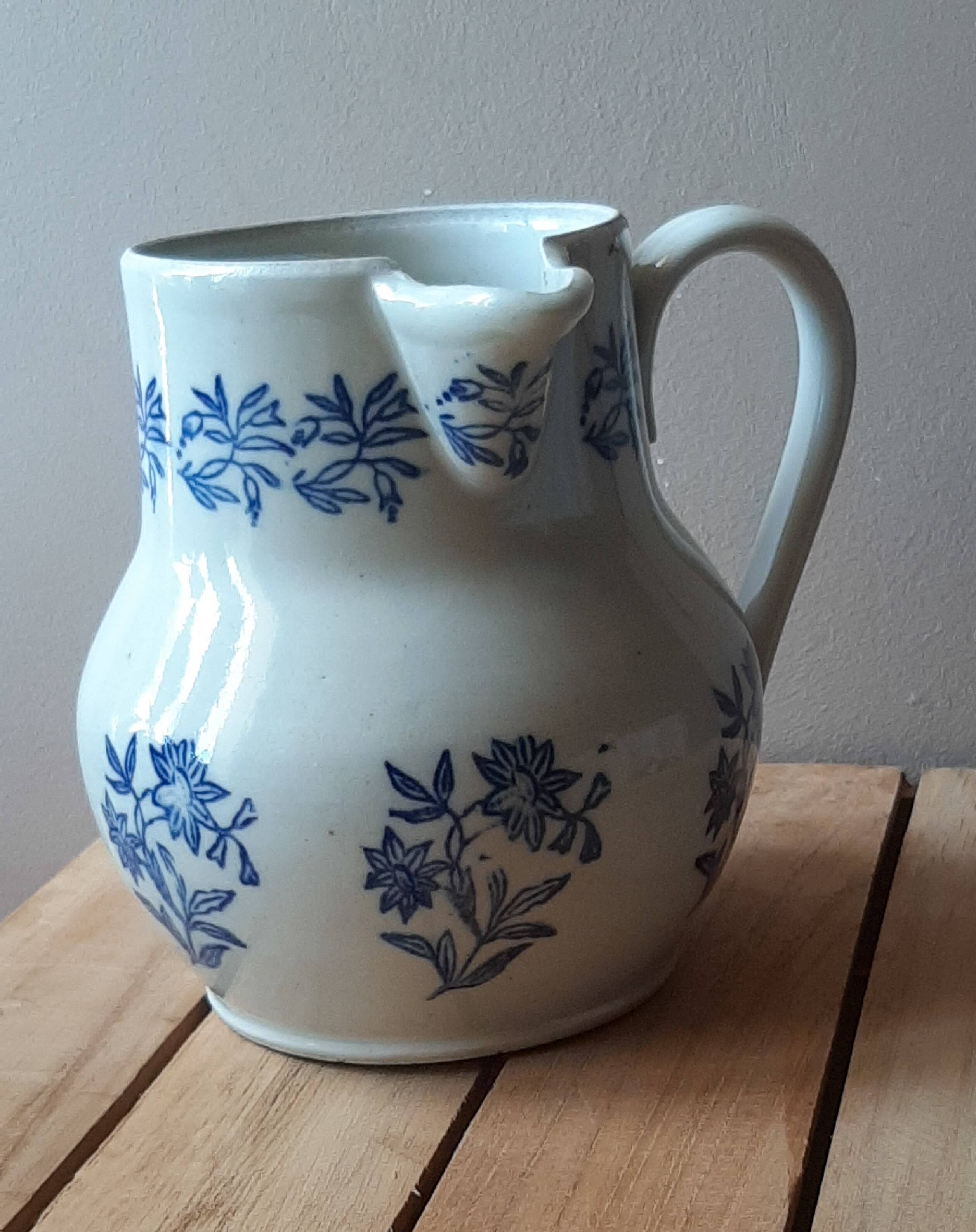 Large antique cruet in Saint Uze earthenware with blue flowers.