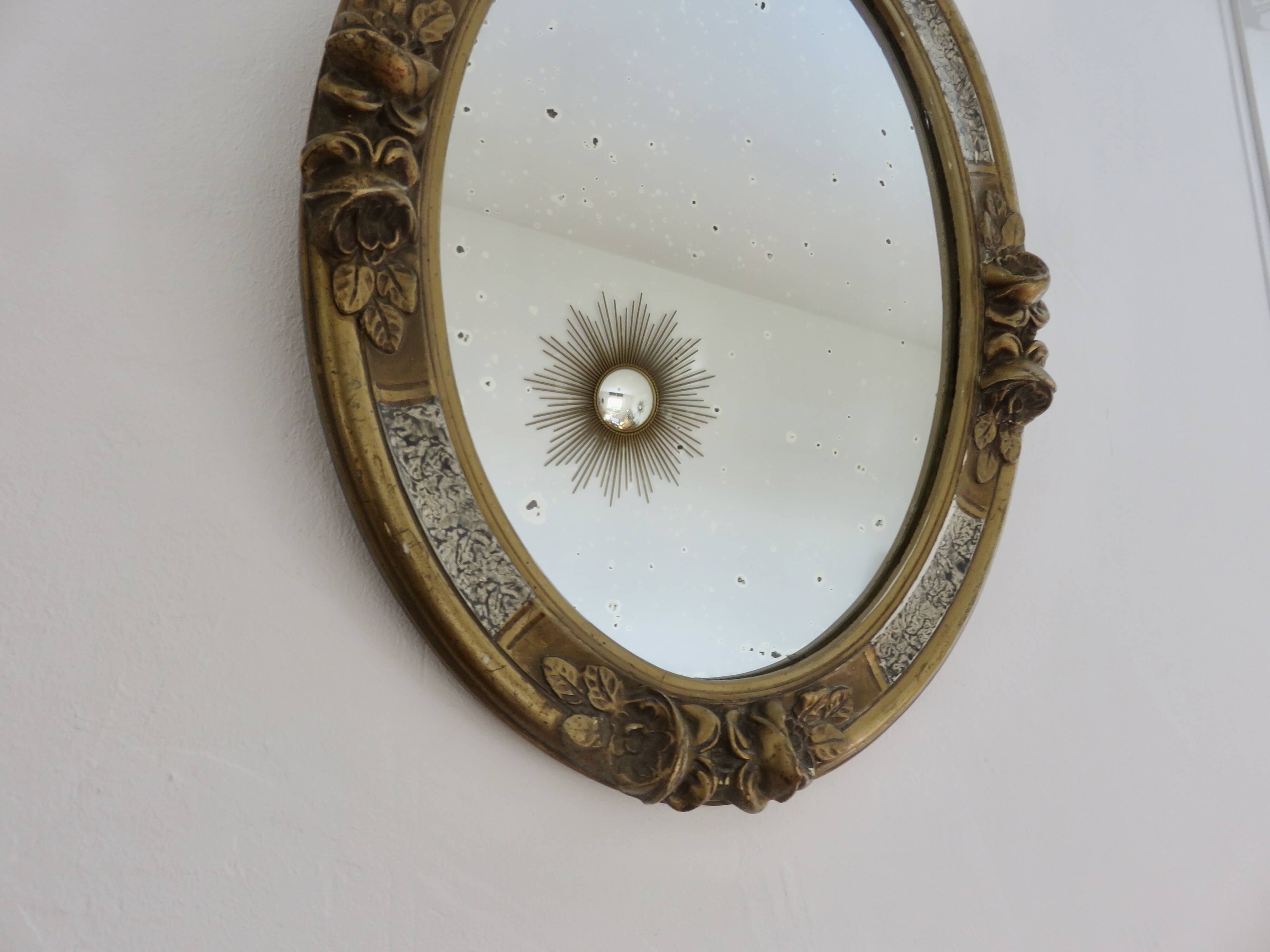 Oval wall mirror, golden floral pattern in stucco and wood, late 19th century